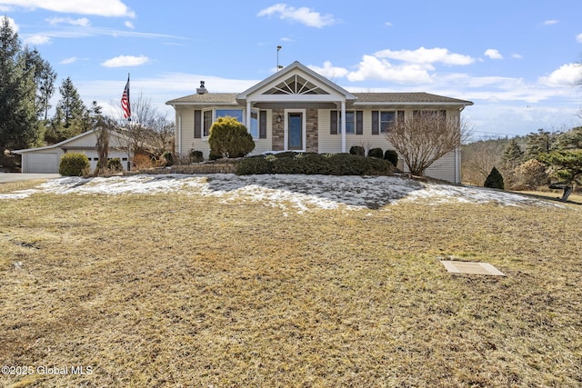 ranch-style home featuring stone siding and a detached garage