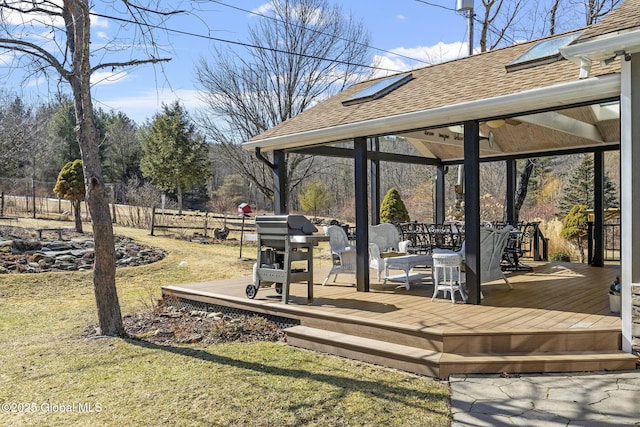 wooden terrace with a yard, fence, and a gazebo