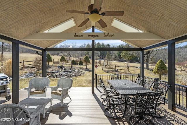 deck featuring grilling area, a gazebo, a ceiling fan, outdoor dining space, and fence