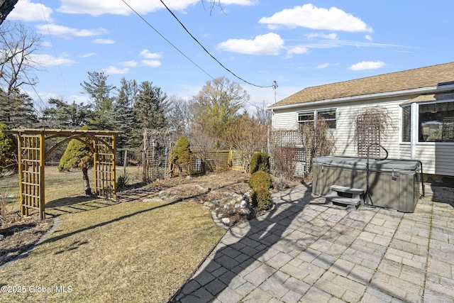 view of patio / terrace with fence and a hot tub