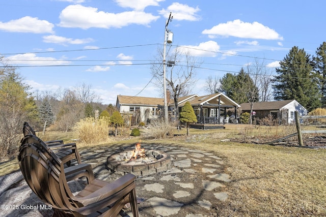 back of house featuring an outdoor fire pit