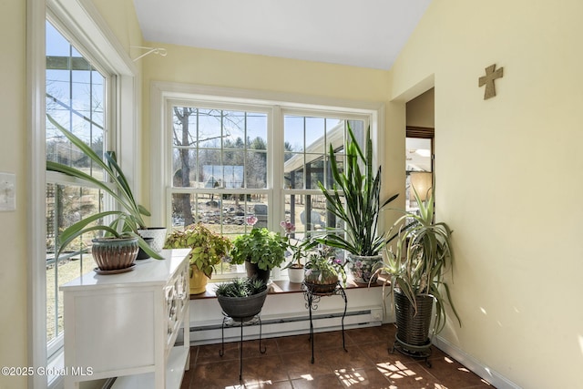 sunroom / solarium featuring a baseboard heating unit and a wealth of natural light