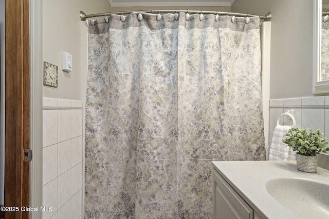 bathroom featuring vanity, tile walls, and a shower with curtain