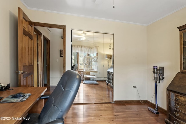 office with baseboards, wood finished floors, and crown molding