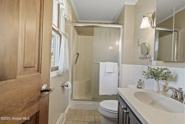 full bath featuring tile patterned flooring, toilet, vanity, ornamental molding, and a stall shower