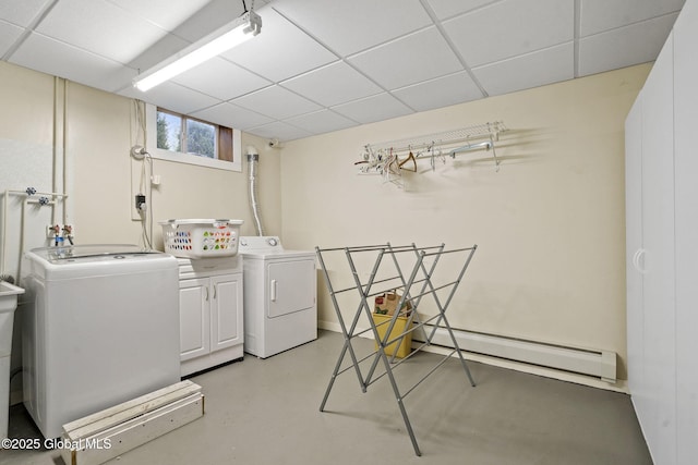 washroom with cabinet space, a baseboard radiator, and washer and clothes dryer