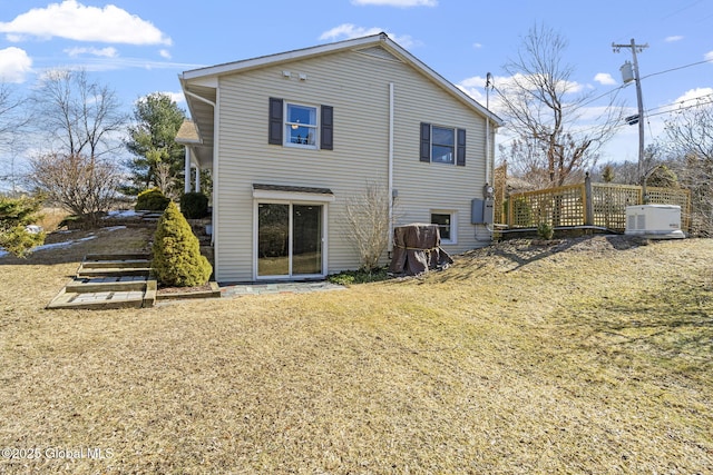 rear view of property featuring a lawn