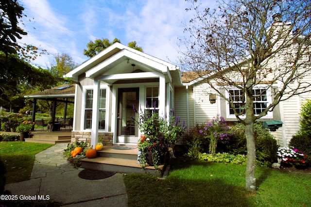 view of front of house featuring stone siding and a front lawn