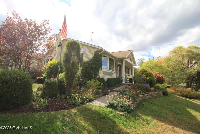 view of side of property with a lawn