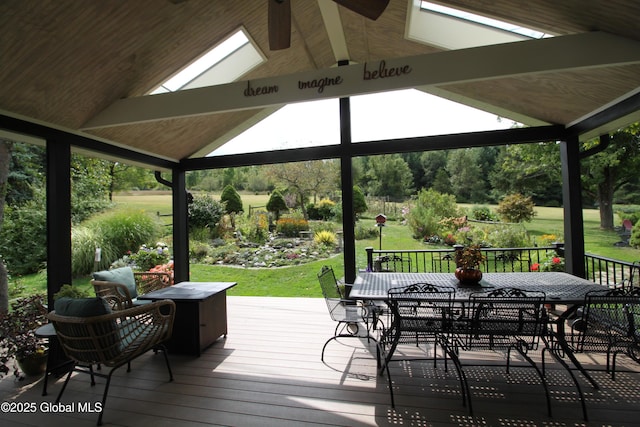 wooden terrace featuring outdoor dining area, a yard, and a gazebo