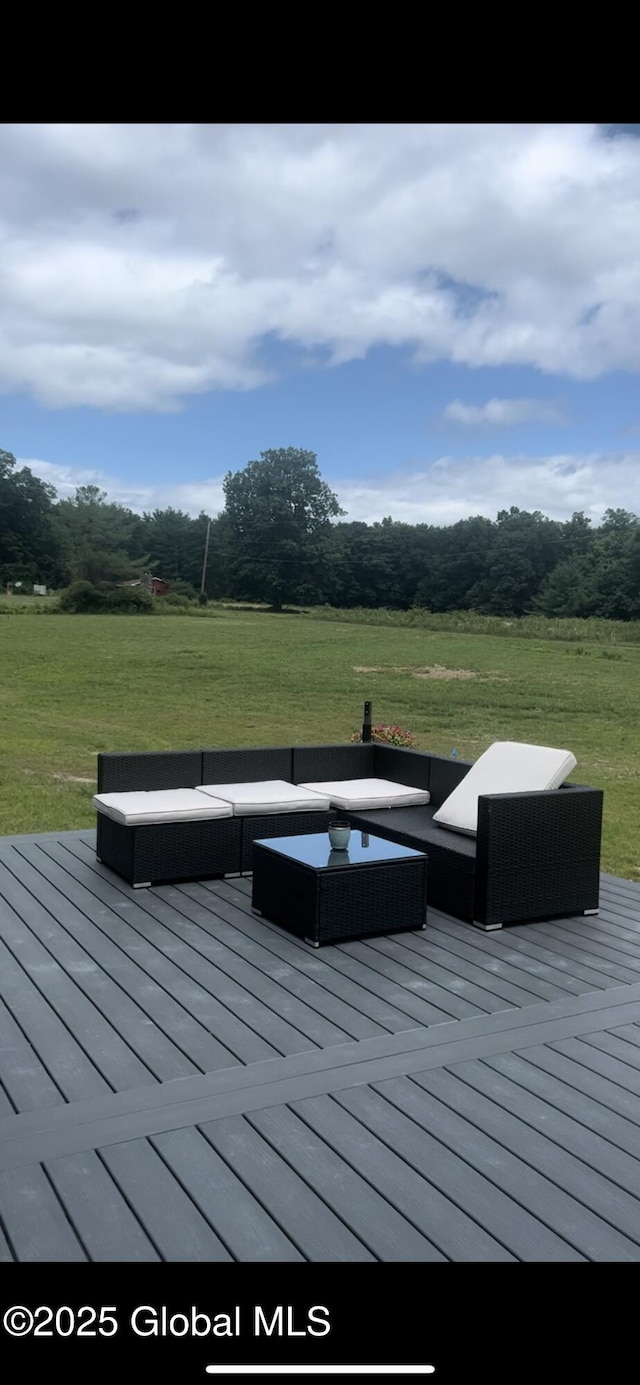 wooden deck with an outdoor hangout area and a lawn