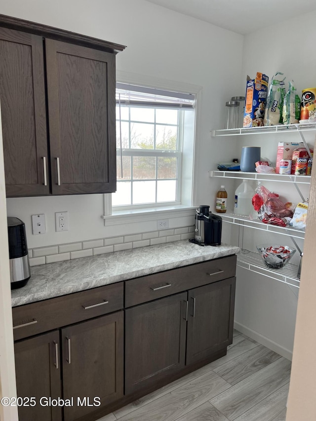 kitchen with dark brown cabinetry and light countertops