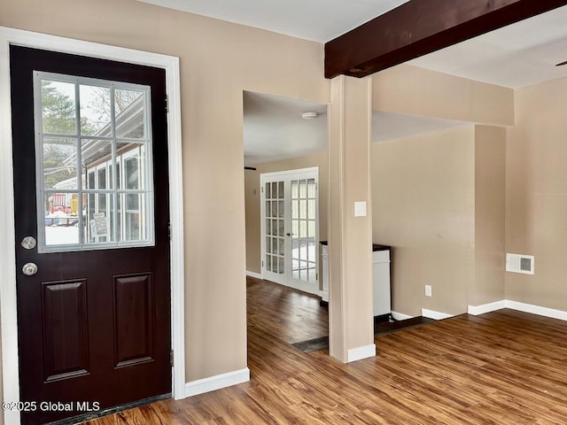 entrance foyer with wood finished floors, visible vents, baseboards, french doors, and beamed ceiling