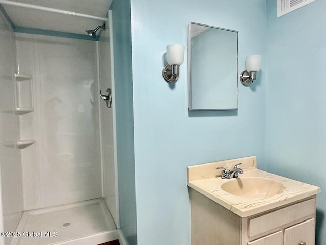 bathroom featuring a shower stall, visible vents, and vanity