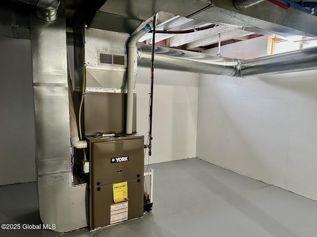 utility room with heating unit and visible vents