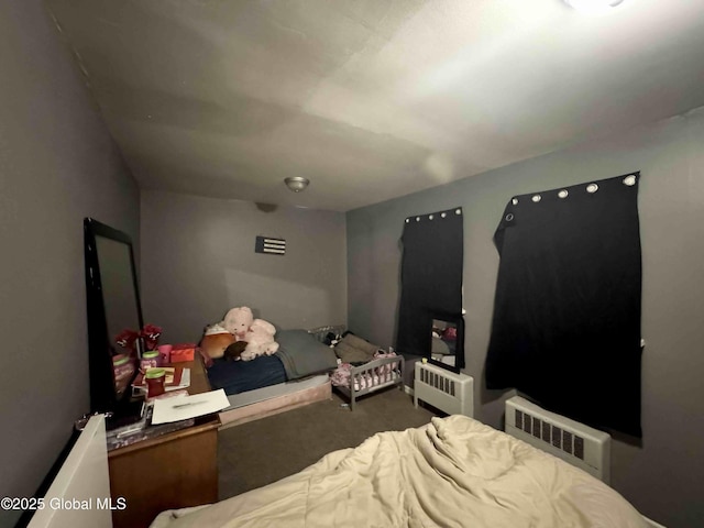 carpeted bedroom featuring radiator heating unit