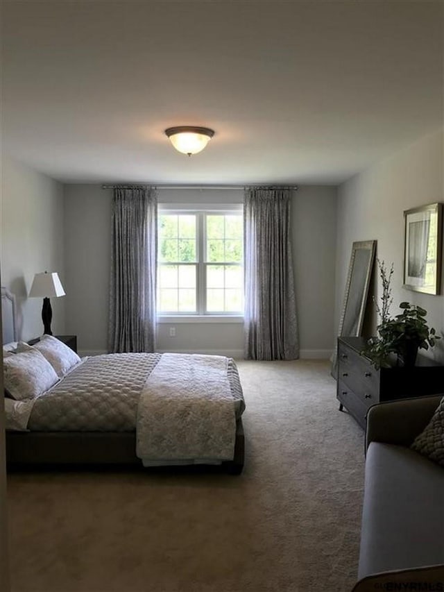 carpeted bedroom with baseboards