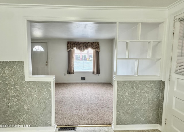 carpeted entryway with visible vents and baseboards