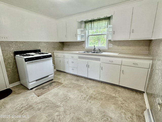 kitchen with white range with gas cooktop, open shelves, a sink, light countertops, and a baseboard heating unit