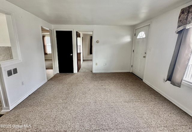 interior space with visible vents, baseboards, and carpet