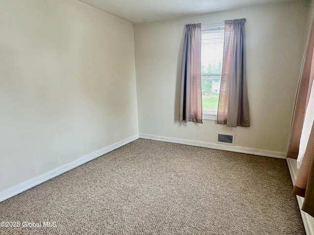 empty room with visible vents, baseboards, and carpet floors