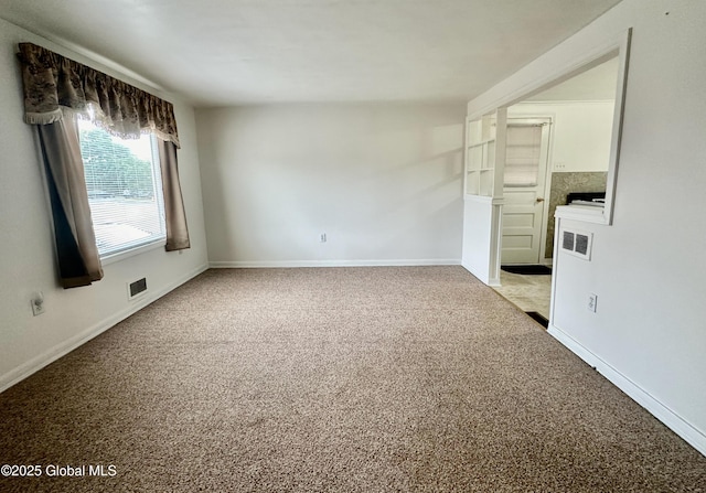 spare room with visible vents, light carpet, and baseboards