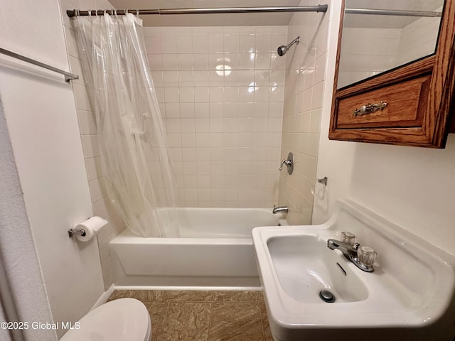 full bathroom featuring a sink, shower / tub combo with curtain, and toilet