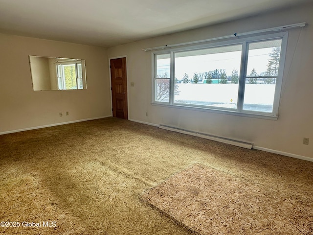 empty room featuring baseboards, baseboard heating, and a healthy amount of sunlight