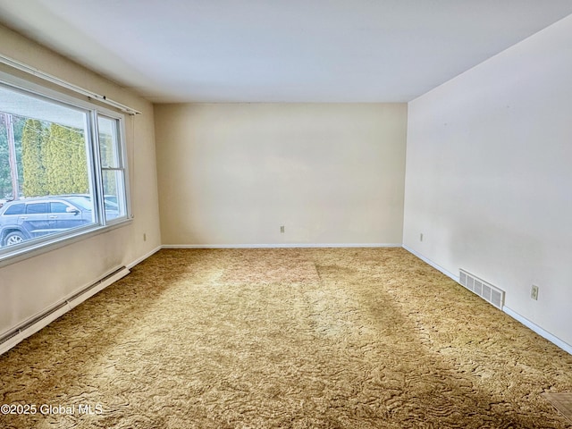 carpeted spare room featuring visible vents, baseboards, and baseboard heating