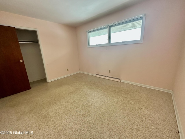 unfurnished bedroom featuring a closet, baseboards, and a baseboard radiator