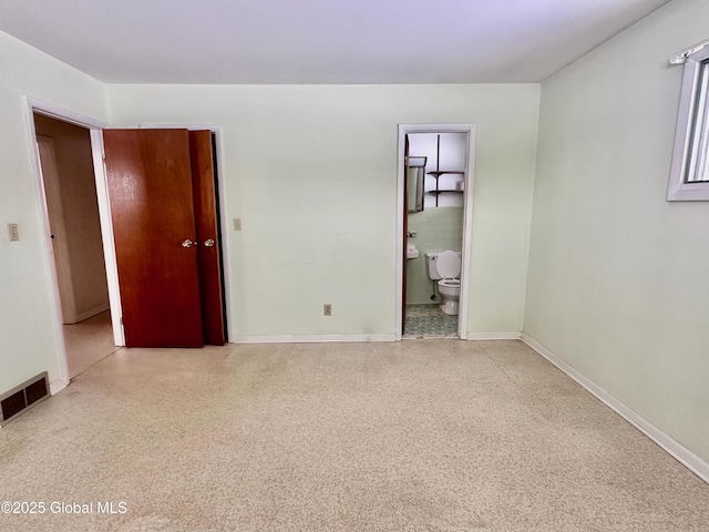 unfurnished bedroom with speckled floor, baseboards, and visible vents