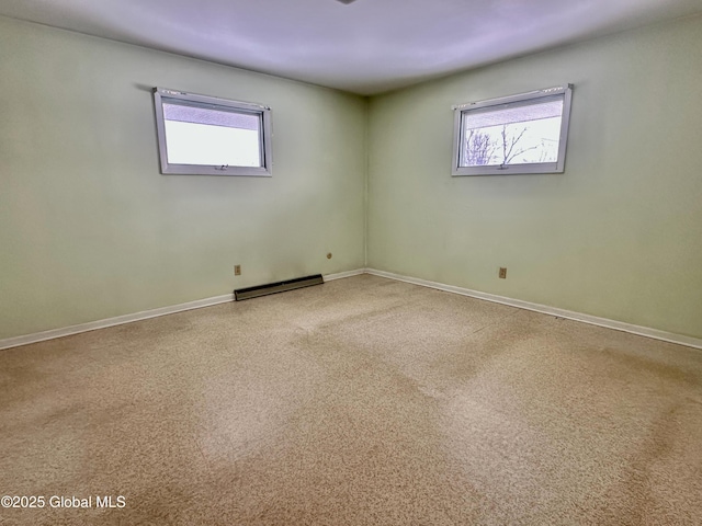 empty room with baseboards and a baseboard radiator