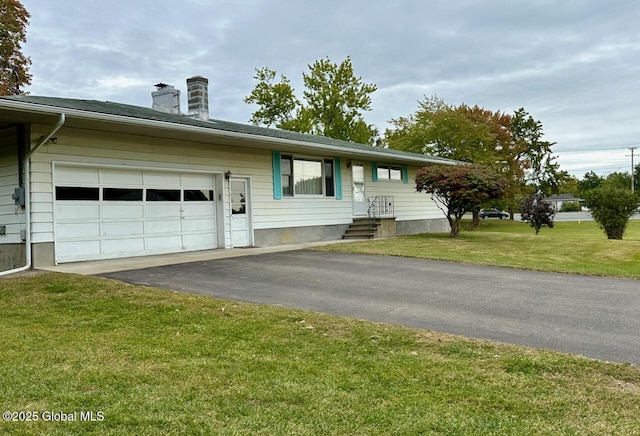 ranch-style house with a front lawn, an attached garage, driveway, and a chimney