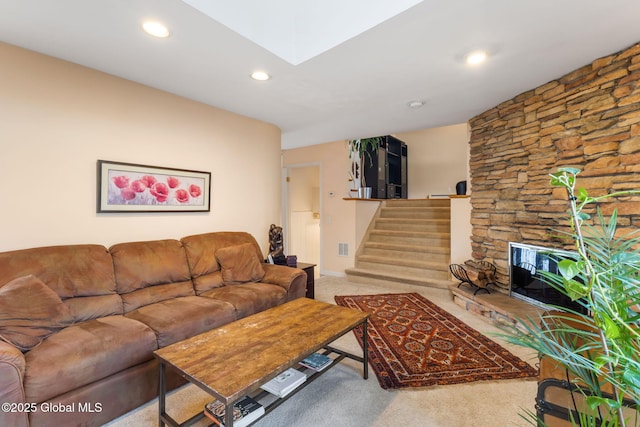 carpeted living room with a skylight, recessed lighting, visible vents, stairway, and baseboards