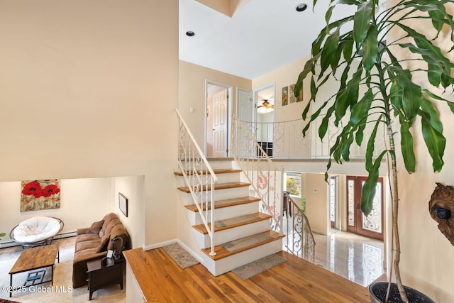 stairs featuring a high ceiling