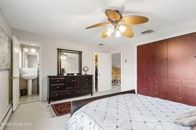 bedroom with carpet floors, a closet, visible vents, a baseboard heating unit, and a ceiling fan