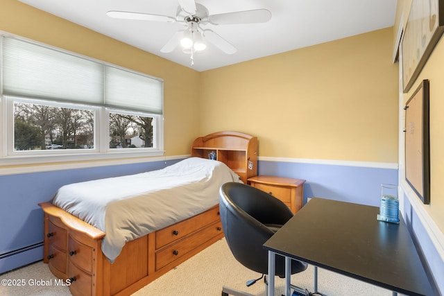 bedroom with a baseboard radiator and a ceiling fan