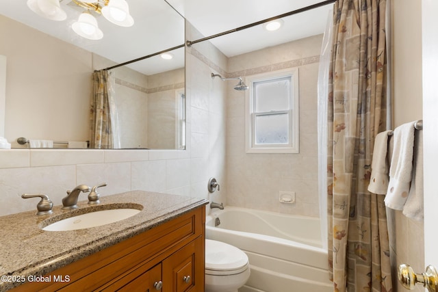 full bathroom with tile walls, toilet, decorative backsplash, shower / tub combo, and vanity