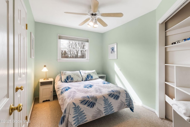 bedroom with light carpet, ceiling fan, and baseboards