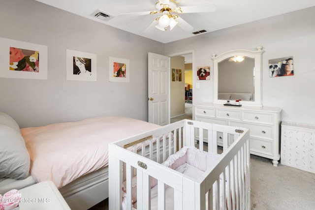 bedroom featuring visible vents, ceiling fan, and light carpet