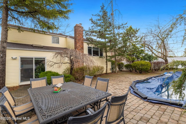 view of patio with a fenced in pool and outdoor dining area