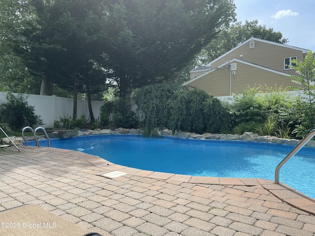 view of swimming pool with a fenced in pool, fence, and a patio