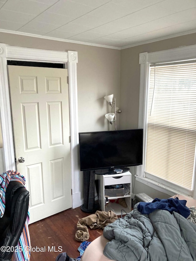 bedroom featuring dark wood-type flooring and ornamental molding