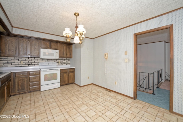 kitchen with white appliances, light countertops, wallpapered walls, and decorative light fixtures