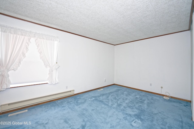 spare room featuring ornamental molding, a baseboard radiator, a textured ceiling, and baseboards