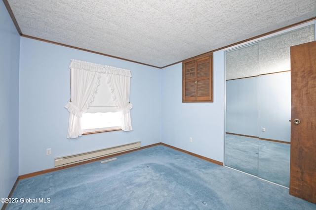 unfurnished bedroom with a closet, a baseboard heating unit, carpet flooring, a textured ceiling, and baseboards