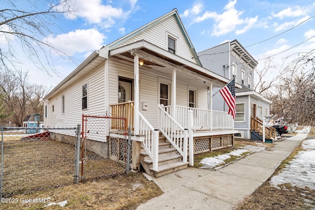 view of front facade featuring covered porch and fence