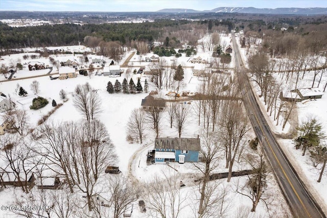 snowy aerial view with a mountain view