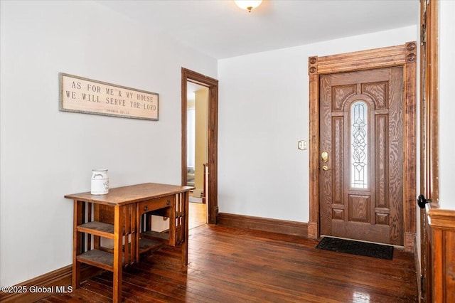 entrance foyer with dark wood finished floors and baseboards