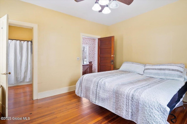 bedroom featuring wood finished floors, a ceiling fan, and baseboards